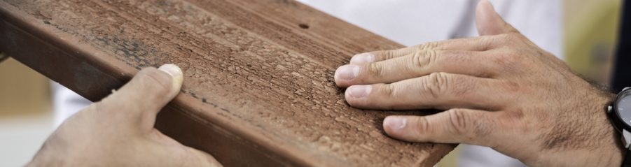 Hands touching surface structure of roof- and façade clay tile "Urban"