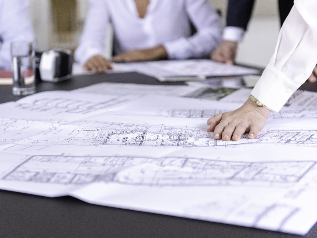 Blueprints at conference table