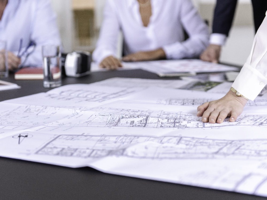 Blueprints at conference table